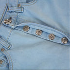 Close-up of leather cross embroidery on jeans