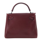 Brown leather handbag with a visible brand logo on a white background