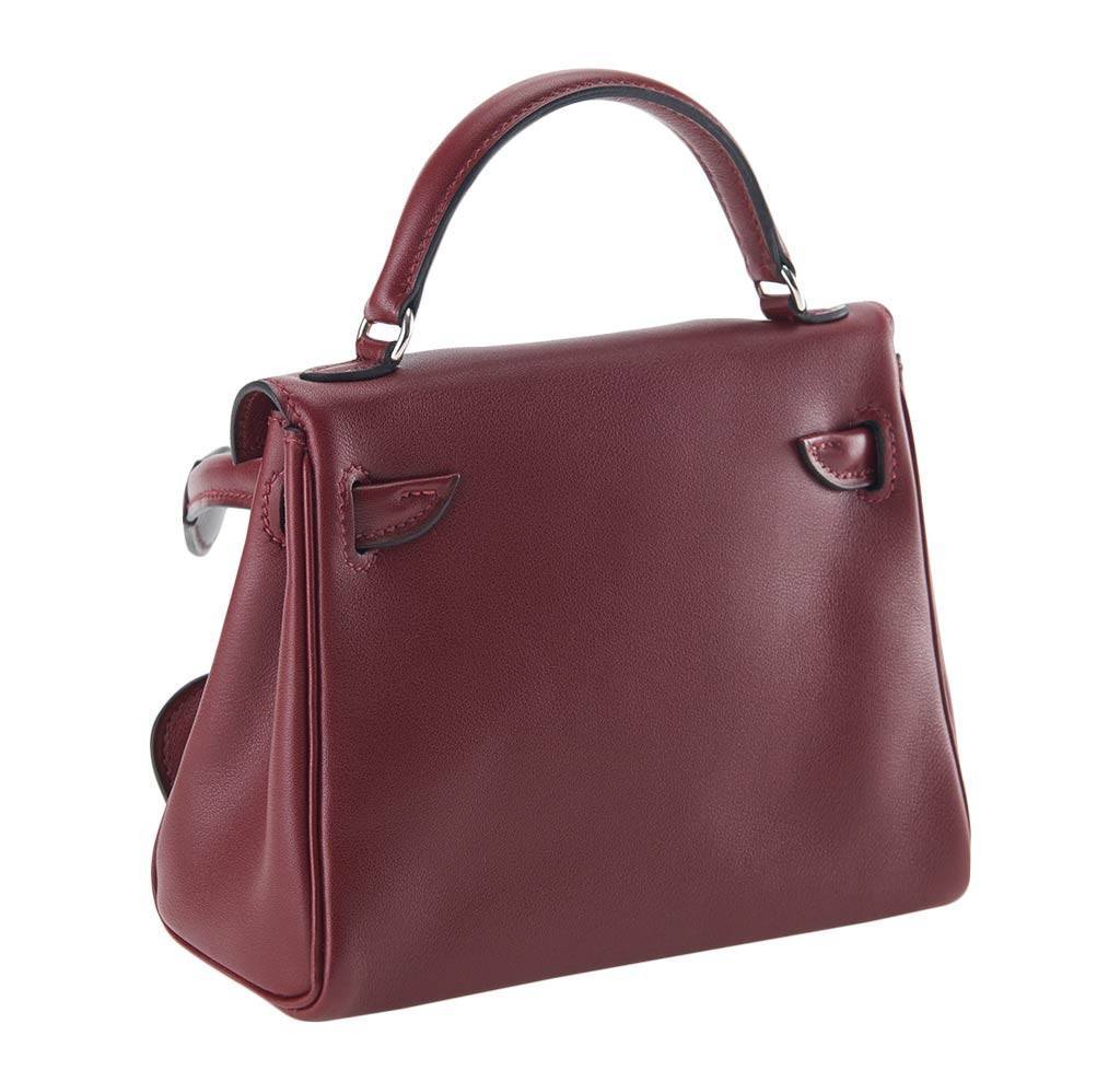 Maroon handbag with a silver clasp on a white background